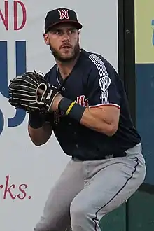 A baseball player in navy and gray