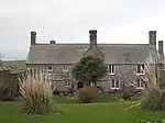 Pendeen Manor House and adjoining wall to south-east