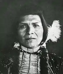 Black and white photo: portrait of a Native American.