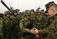 Chairman of the Joint Chiefs of Staff Peter Pace shakes hands with Chinese tankers at Shenyang in 2007