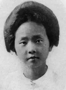 A young Chinese woman with dark hair arranged in a bouffant updo