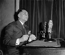 Quezon speaking into two NBC microphones