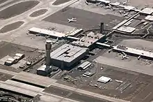 aerial view of Sky Harbor airport, showing the spoke structure of the terminals and gates, with the spike of the control tower toward the lower left of the picture.