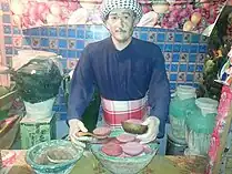 Sculpture of a meat Vendor surrounded by pots