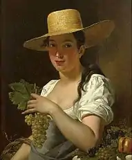 Young woman with hat and grapes