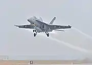 A Strike Fighter Wing Atlantic F/A-18 takes off from Naval Air Station Fort Worth Joint Reserve Base for the memorial flyover on December 6, 2018.