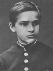 A black-and-white photograph of a young boy, looking towards the right