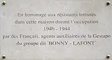 Commemorative plaque with the inscription "In hommage to Resistance members tortured in this house during the occupation 1940-1944, by French agents of the Gestapo from the group known as "Bonny-Lafont"