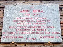 A plaque on a wall in Rome, describing Abebe's victory