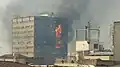 Plasco Building on fire prior to collapse in 2017.