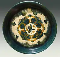 "Offering plate" with sancai glaze, decorated with a bird and trees, 8th century.