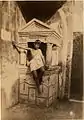 Vincenzo Galdi as a boy sitting on a lararium at Pompeii