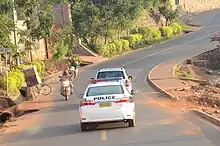 View of a police car following another car on a street.