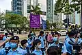 Police officers raised the purple and blue flags to the citizens lining up outside the court building