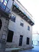 Side of the house with its second floor balcony