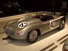 A rear three-quarters view of a silver RS60 Spyder