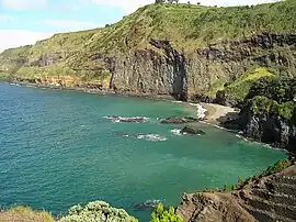 A view of Baixo da Areia beach along the southern coastal area, separated from the village of Caloura