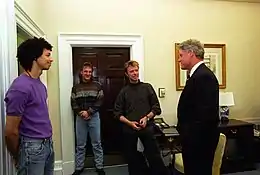 A group of men standing together in an office