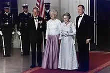 President George H. W. Bush and First Lady Barbara Bush with Queen Elizabeth II and Prince Philip, Duke of Edinburgh at the beginning of an official dinner at the White House, 1991