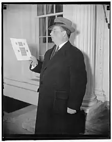 Phillip H. Ward of Philadelphia, holding part of his $100,000 rare stamp collection which he brought to the White House to view by President. Washington, D.C., Dec. 9, 1937