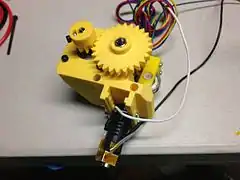 Prusa i3 extruder and hot end with yellow printed parts.