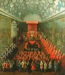 Scarlet is the traditional color of the British nobility. Queen Anne addresses the House of Lords (1708-1714), whose members wear their red ceremonial robes.