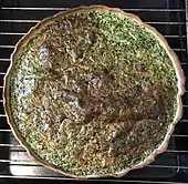 Picture of a round, open tart with dark filling