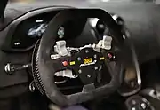 Racing steering wheel with hand controls for all functions