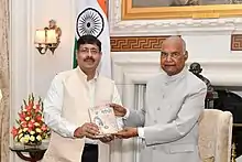 Pandey (left) gifting Gandhi Aur Hindi to Ram Nath Kovind (right)