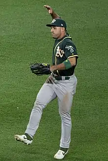 A baseball player in green and gray