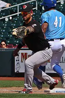 A baseball player in black and gray