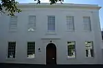 Ravenswood House is the only known example in Cape Town of the late classical Georgian architectural style of the beginning of the 19th century. This double-storeyed building was probably erected between 1817 and 1835 by M. A. de Kock as one of a series o Type of site: House.