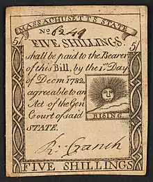 A Massachusetts five-shilling note issued in 1779 with the inscription: "FIVE SHILLINGS. shall be paid to the Bearer of this Bill, by the 1st Day of Decmr. 1782 agreeable to an Act of the Genl, Court of said STATE." ; Within print of sun: "RISING".