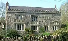 Gray stone building with a slate roof.