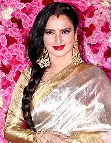 Rekha is looking at the camera.