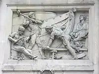 A relatively modern high relief (depicting shipbuilding) in Bishopsgate, London. Some elements jut out of the frame of the image.