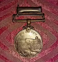 Reverse of the Sainya Seva Medal with depiction of Purana Qila.