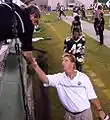 The Band Director shakes hand during a game