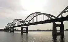 A large arch bridge crossing a wide river