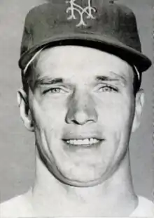 A close-up of a man wearing a baseball cap with "NY" on the front.