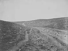 A view of the "Valley of the Shadow of Death" near Sevastopol, taken by Roger Fenton in March 1855.  It was so named by soldiers because of the number of cannonballs that landed there, falling short of their target, during the siege.