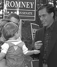 Man smiling at right with sign in background and parents holding toddler at left