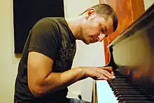 Roy Zu-Arets plays the piano in his studio in Hollywood