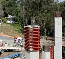 Column formwork: This column has been cast within a single segmented formwork, here undergoing disassembly from the bottom upward.