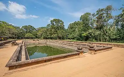 Large rectangular artificial pond with carved stone sides