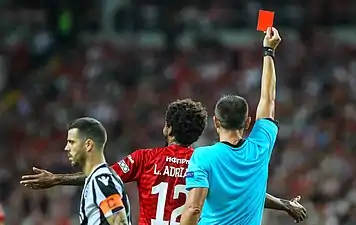 A footballer is shown a red card and ejected from a soccer match.