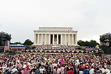 Trump addressing the crowd at the Lincoln Memorial. An M2 Bradley tank can be seen either side of him.