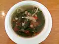 A soup containing mushroom and Corchorus olitorius leaves, served in Malolos, the Philippines, where the latter vegetable is known as saluyot.