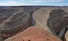 View of a river winding through a series of narrow gorges that dramatically double back on each other