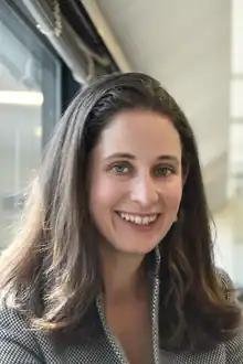 Headshot portrait of Sara Aviel, a brown-haired woman.